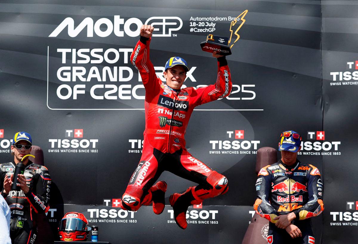 Ducati Lenovo Team’s Marc Marquez celebrates with a trophy on the podium after winning the MotoGP race REUTERS/David W Cerny TPX IMAGES OF THE DAY