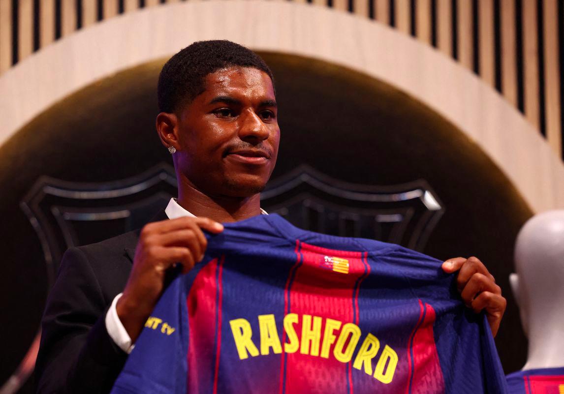 Football - FC Barcelona present new player Marcus Rashford - FC Barcelona Club Shop, Barcelona, Spain - July 23, 2025Barcelona's new signing Marcus Rashford poses with his shirt during the presentation - REUTERSPIX