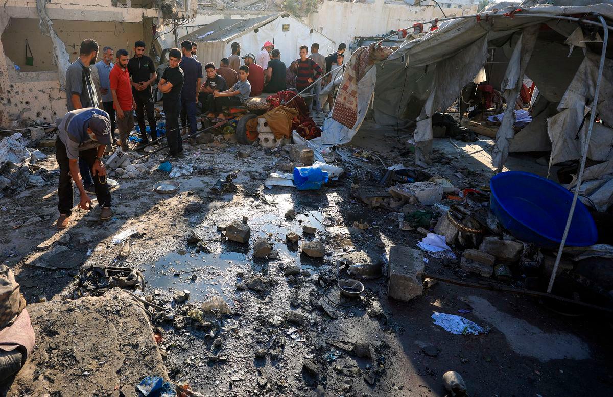 Palestinians inspect the damage at the site of an overnight Israeli strike on a tent sheltering displaced people, in Gaza City - Reuterspix