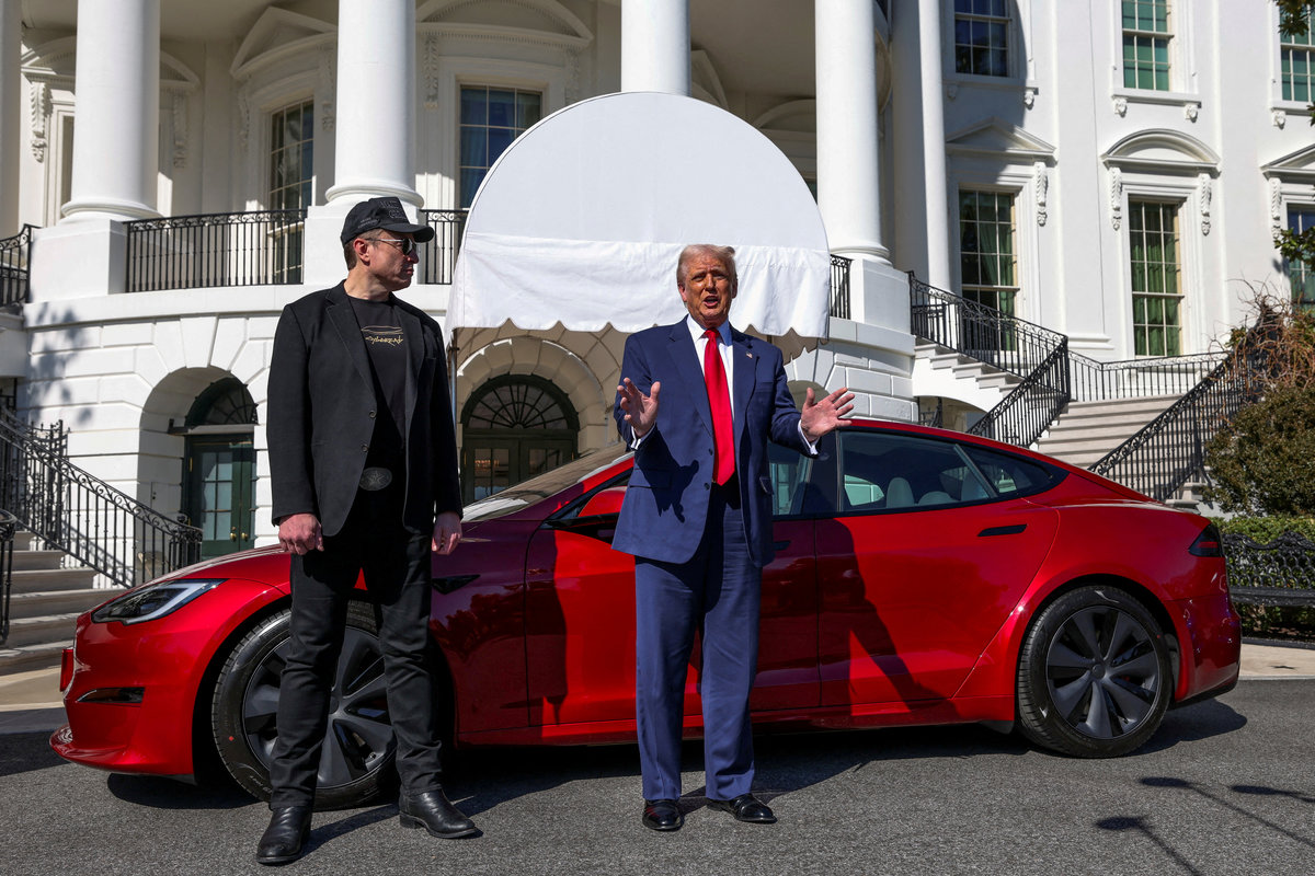U.S. President Donald Trump talks to the media next to Tesla CEO Elon Musk, at the White House in Washington, D.C., U.S., March 11, 2025. - REUTERS