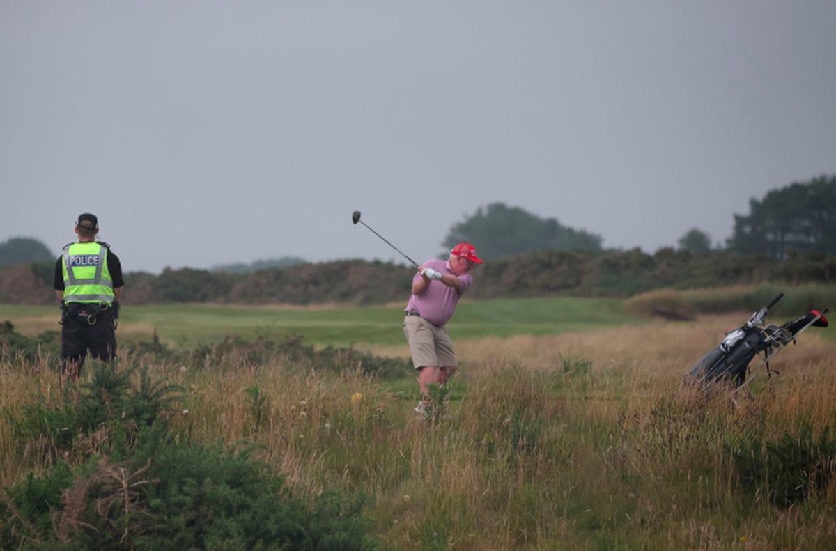 A police officer watches a golfer tee off on a hole on the Trump Turnberry golf course ahead of the expected arrival of U.S.President Donald Trump later this week in Turnberry, Scotland, Britain, July 24, 2025. - REUTERSPIX