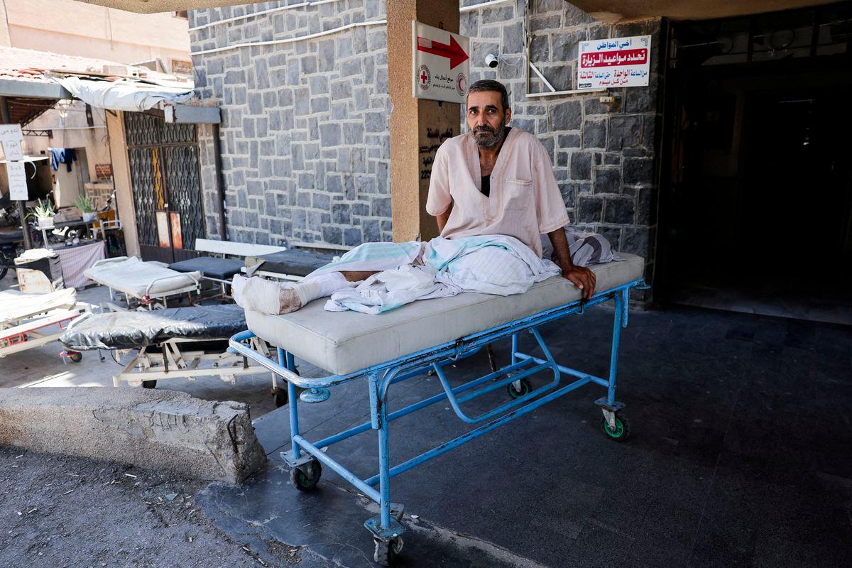 A man sits on a stretcher outside a hospital, following deadly clashes between Druze fighters, Sunni Bedouin tribes and government forces, in Syria's predominantly Druze city of Sweida, Syria July 25, 2025. - REUTERSPIX