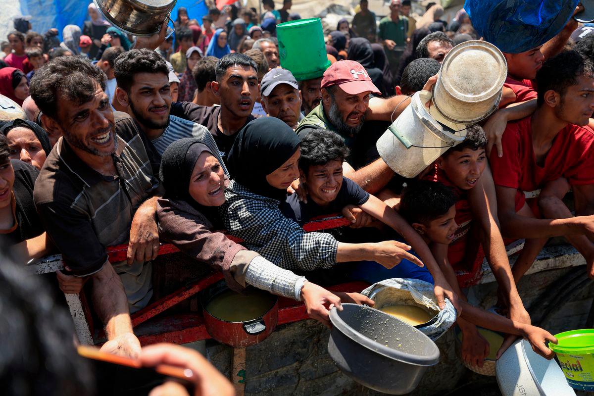 Palestinians gather to receive food from a charity kitchen, amid a hunger crisis, in Gaza City, July 25, 2025. - REUTERSPIX