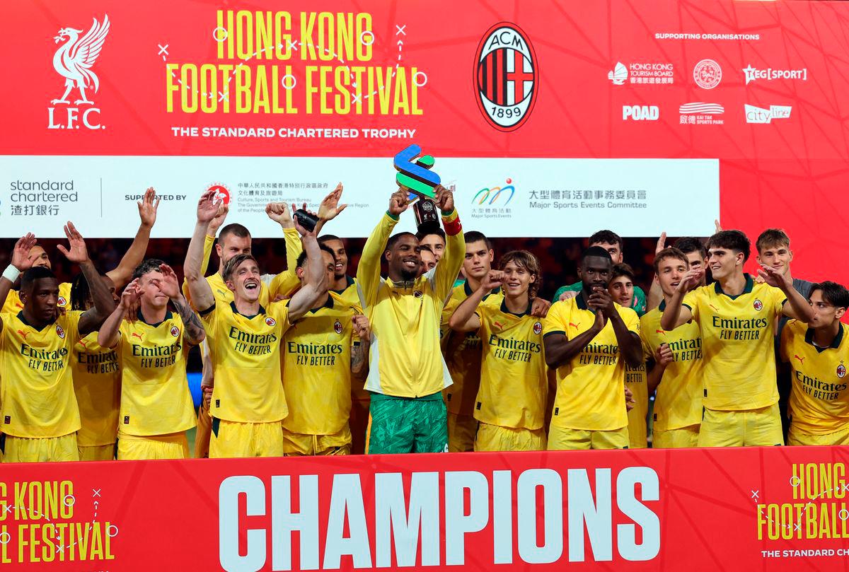 AC Milan players celebrate with a trophy after the match - REUTERSpix