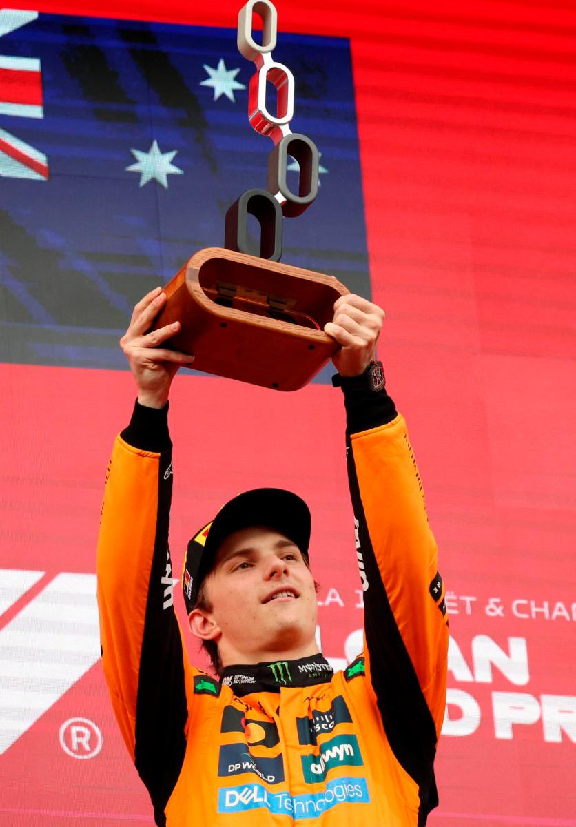 McLaren’s Oscar Piastri celebrates on the podium with a trophy after winning the Belgian Grand Prix - REUTERS