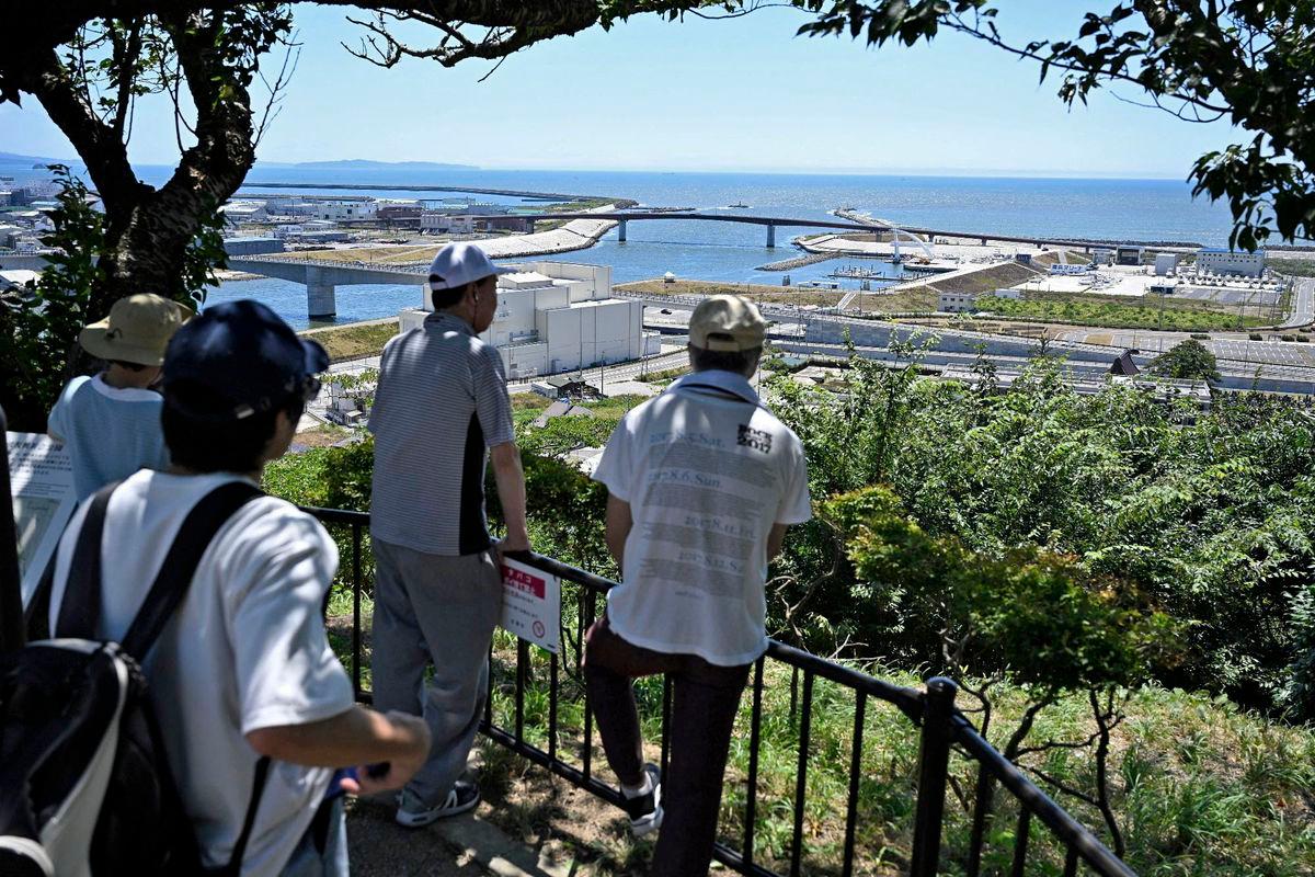 People watch the coastal area from Hiyoriyama Park after Japan issued evacuation alert following major quake in Russia’s Kamchatka Peninsula that triggered a tsunami warning, in Ishinomaki, Miyagi prefecture, Japan July 30, 2025 - Kyodo/via REUTERSPix
