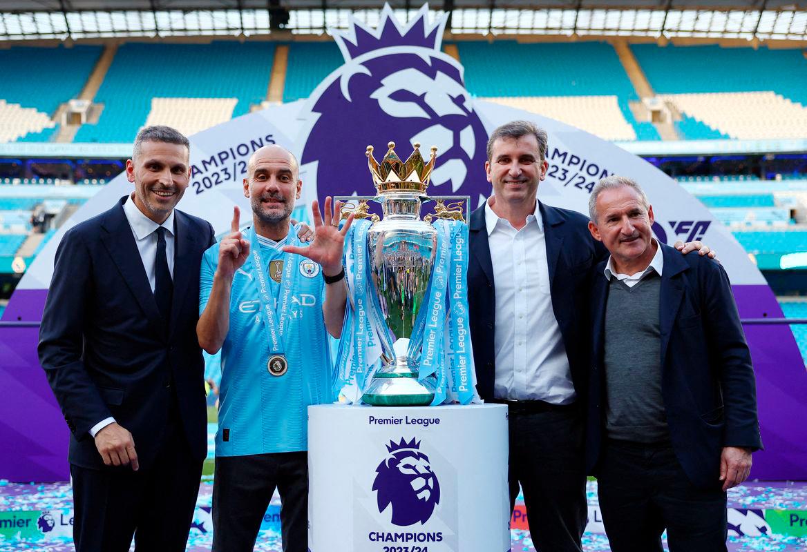 Manchester City manager Pep Guardiola with chairman Khaldoon Al Mubarak, chief executive Ferran Soriano and director of football Txiki Begiristain celebrate with the trophy after winning the Premier League REUTERSpix