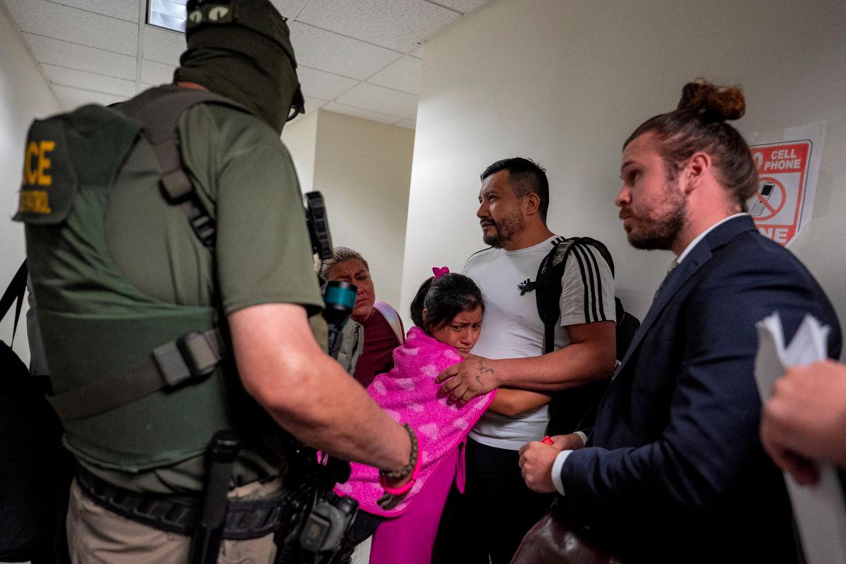 A migrant is embraced by his daughter as he is informed he is going to be detained by federal immigration officers at U.S. immigration court in Manhattan, in New York City, U.S., July 31, 2025. - REUTERSPIX