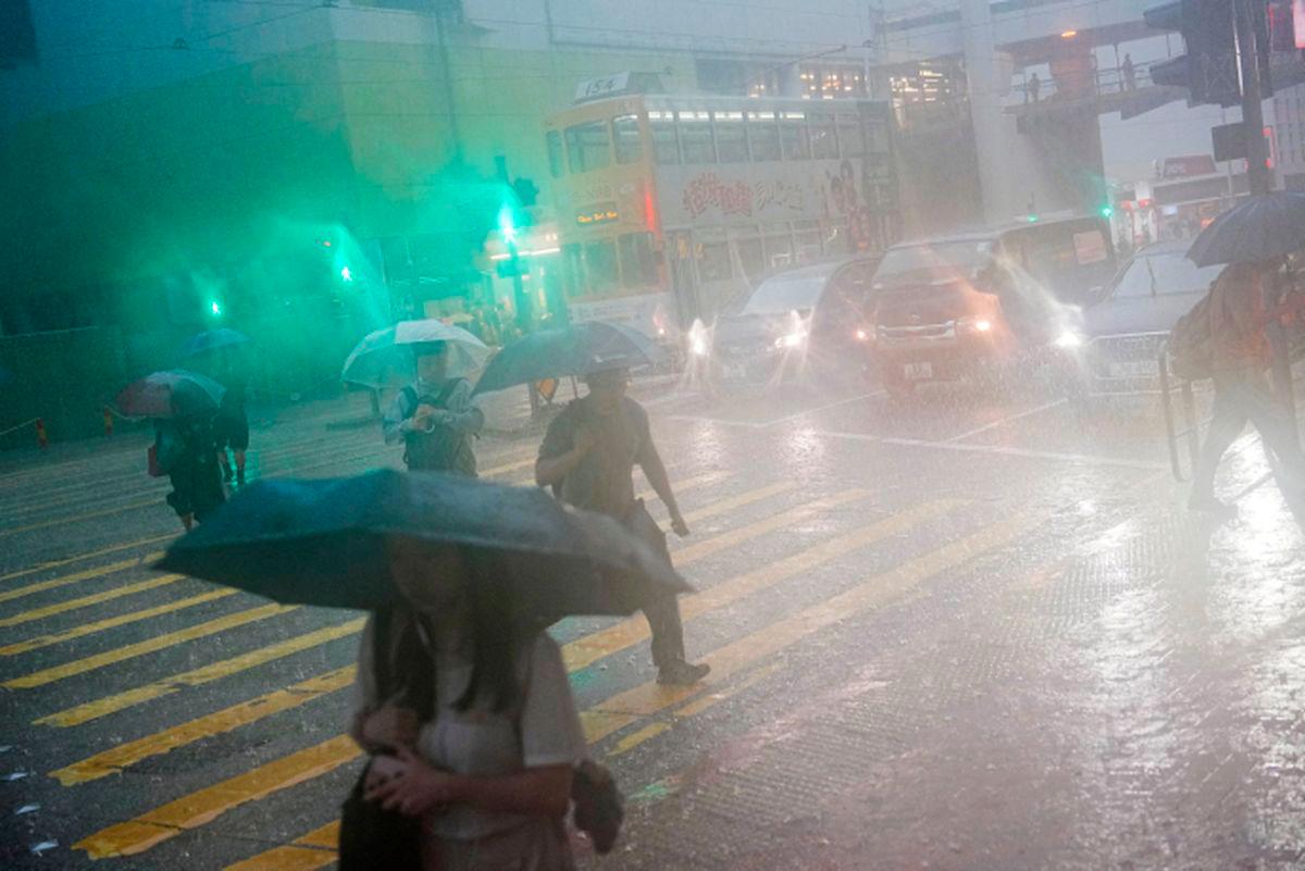 Pedestrians walk past a flooded area during heavy rains, in Hong Kong, China, August 5, 2025. - REUTERSPIX