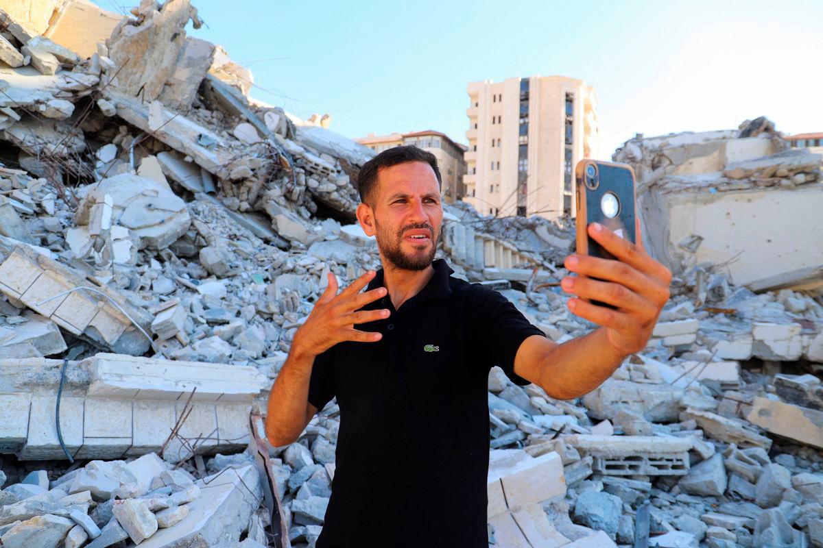 Hearing-impaired Palestinian influencer Basem Al-Habel, who turned to social media to document the war in Gaza through sign language, reaching a wide range of followers from both inside and outside of the enclave, films himself in Gaza City, August 5, 2025. Ebrahim Hajjaj/ REUTERS