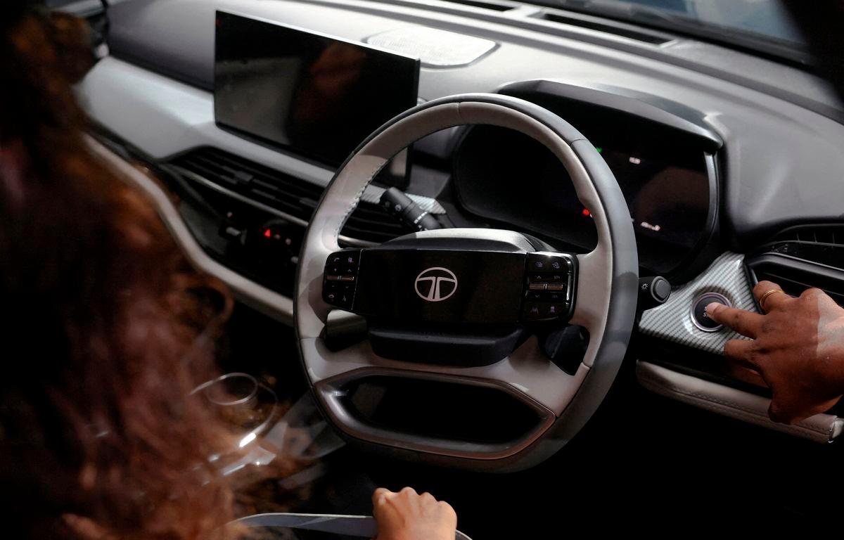 FILE PHOTO: People inspect the interior of the TATA Motors Harrier.ev at a launch event in Mumbai, India, June 3, 2025. Francis Mascarenhas/File Photo/ REUTERS