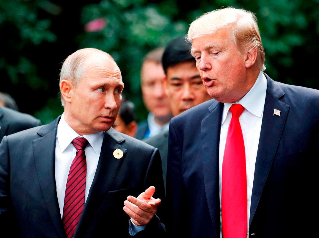 U.S. President Donald Trump and Russia’s President Vladimir Putin talk during the family photo session at the APEC Summit in Danang, Vietnam November 11, 2017 - REUTERSpix