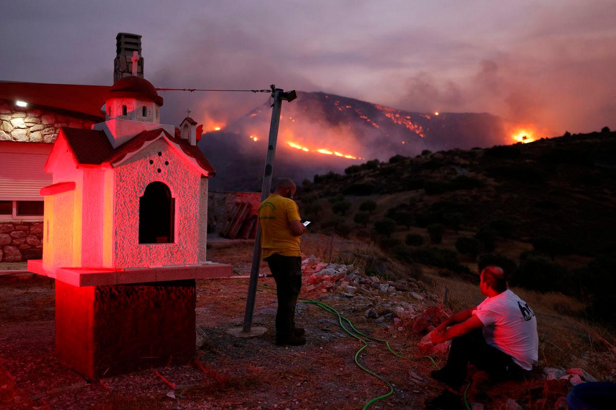 Local residents watch as a wildfire burns in Keratea, near Athens, Greece. Reuterspix
