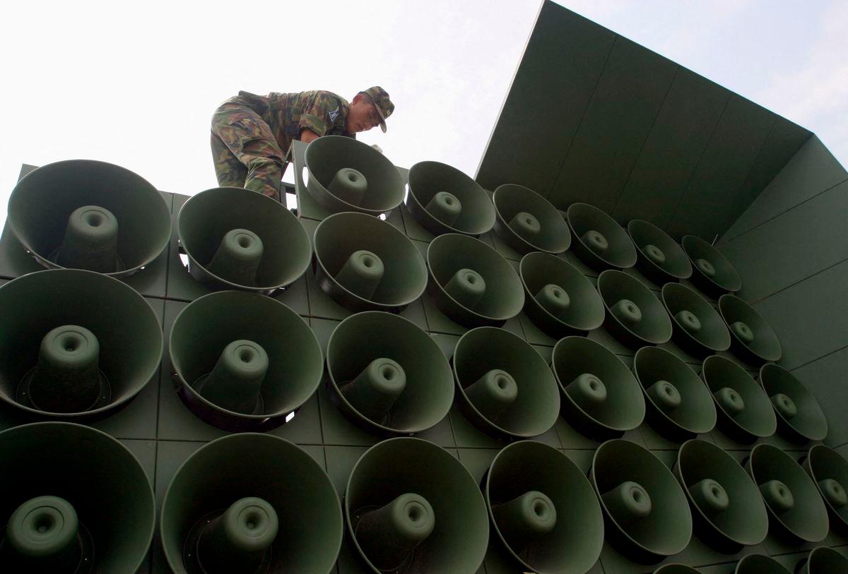 FILE PHOTO: A South Korean soldier works to remove loudspeakers set up for propaganda purposes near the demiltarized zone in Paju, about 55km (34 miles) north of Seoul June 16, 2004. REUTERS/You Sung-Ho/File Photo