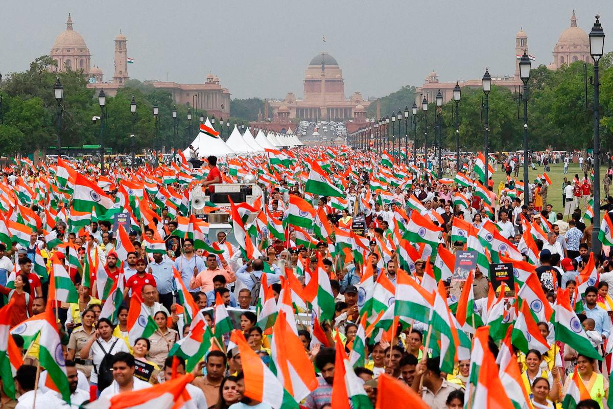FILE PHOTO: People wave Indian flags in support of the Indian Armed Forces, following the ceasefire announcement between India and Pakistan, in Delhi, India, May 13, 2025. REUTERS/Priyanshu Singh/File Photo
