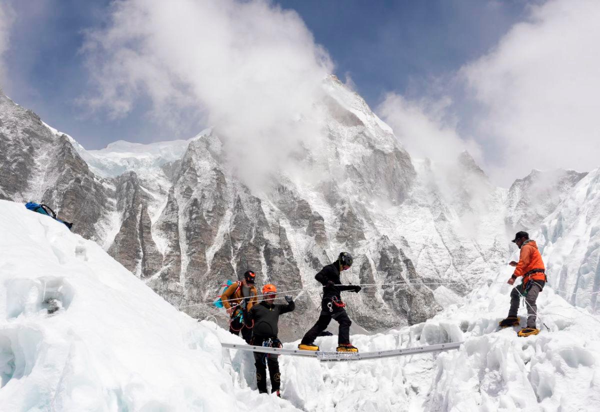 Mountaineers practice walking on a ladder during a training session at Everest base camp, Nepal April 15, 2025. - REUTERS