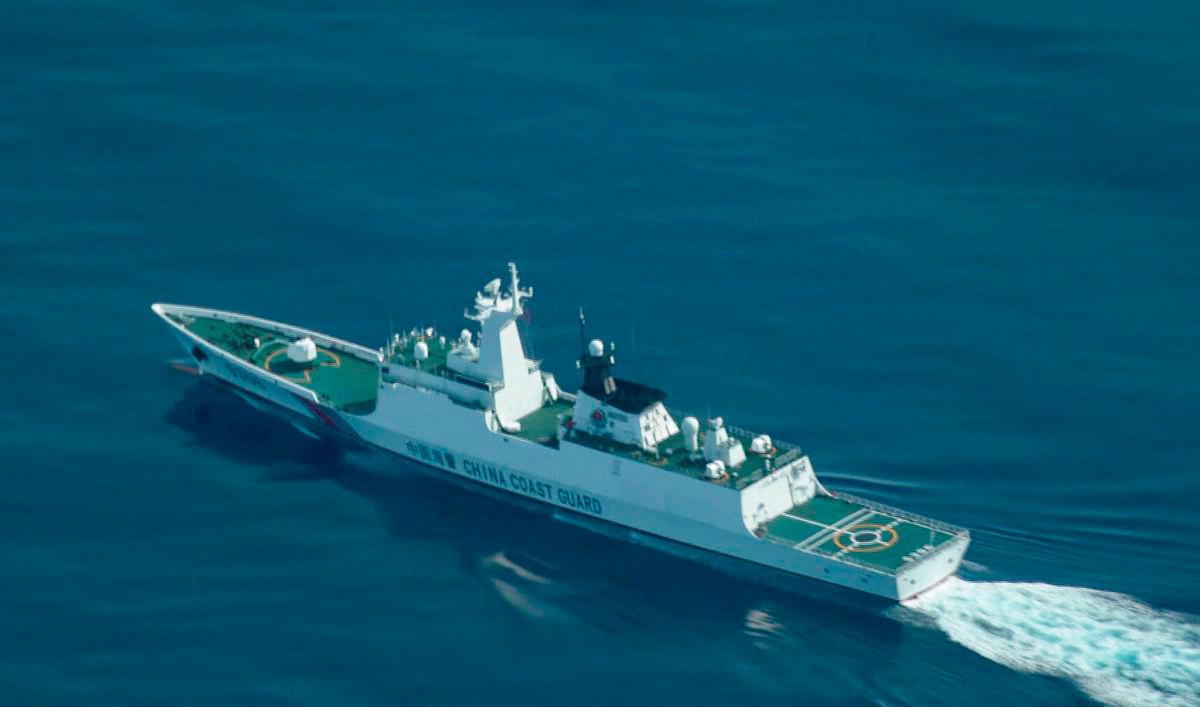 FILE PHOTO: An aerial view of a China Coast Guard ship navigating near the disputed Scarborough Shoal, as Philippine Coast Guard aircraft carrying journalists patrols the area, days after two Chinese vessels collided in the area while allegedly trying to block a Philippine supply mission, in the South China Sea, August 13, 2025. REUTERS/Adrian Portugal/File Photo