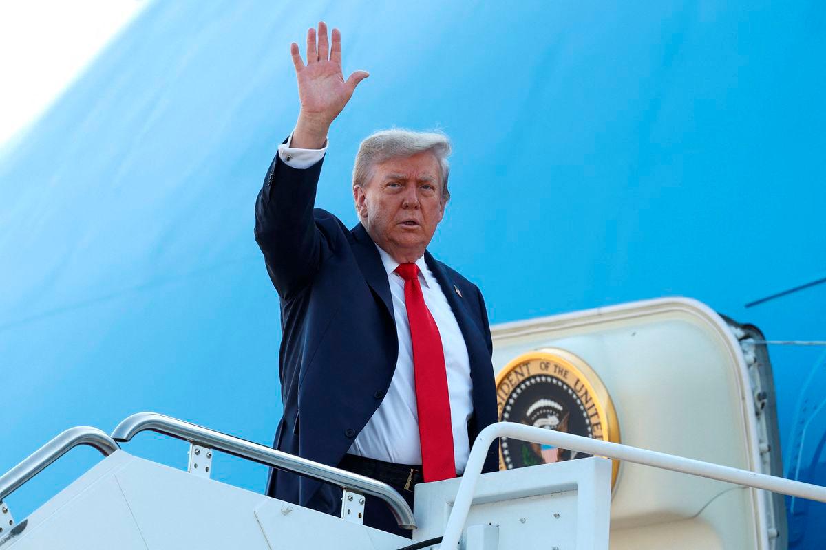 U.S. President Donald Trump boards Air Force One as he departs for Alaska to meet with Russian President Vladimir Putin to negotiate for an end to the war in Ukraine, from Joint Base Andrews in Maryland, U.S., August 15, 2025. REUTERS/Kevin Lamarque