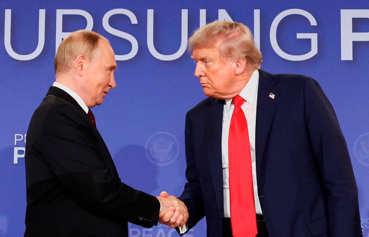 U.S. President Donald Trump and Russian President Vladimir Putin shake hands during a press conference following their meeting to negotiate an end to the war in Ukraine, at Joint Base Elmendorf-Richardson, in Anchorage, Alaska, U.S., August 15, 2025. - REUTERS
