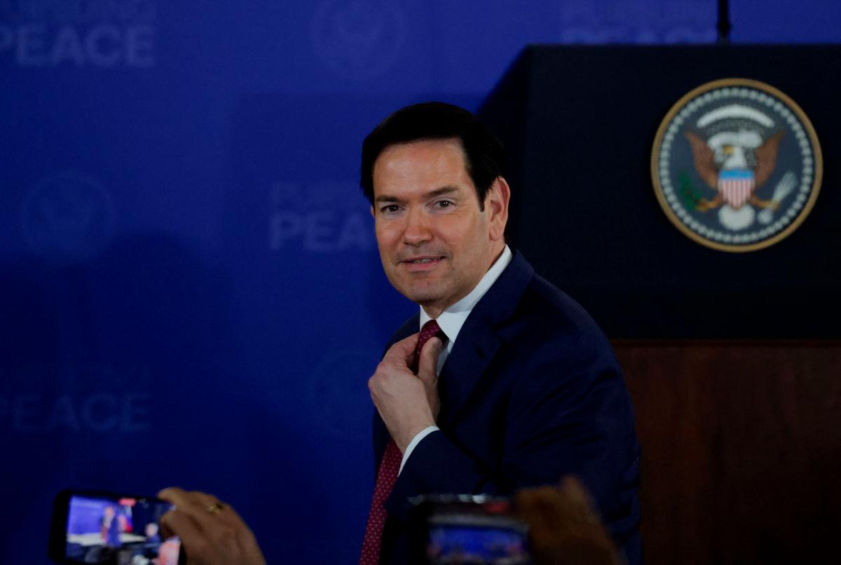 U.S. Secretary of State Marco Rubio adjusts his tie ahead of joint press conference by U.S. President Donald Trump and Russian President Vladimir Putin, following their meeting to negotiate an end to the war in Ukraine, at Joint Base Elmendorf-Richardson in Anchorage, Alaska, U.S., August 15, 2025. REUTERS/Jeenah Moon