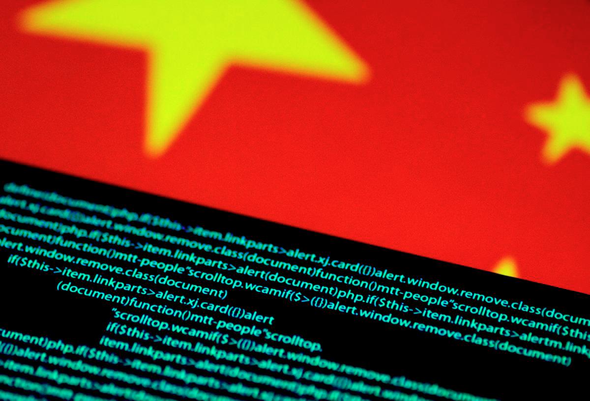 Computer code is seen on a screen above a Chinese flag in this July 12, 2017 illustration photo. - REUTERS