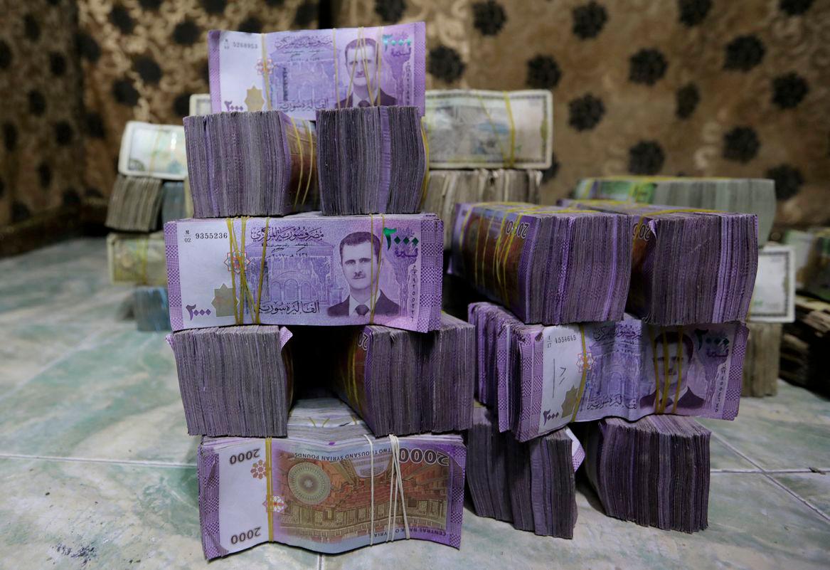 Stacks of Syrian pounds are pictured inside an exchange currency shop in Azaz, Syria February 3, 2020. Picture taken February 3, 2020. - REUTERSPIX