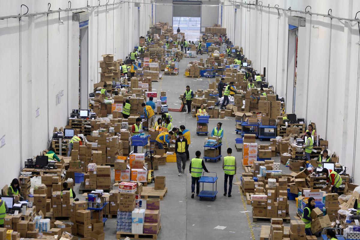 Employees sort boxes and parcels at the logistic centre of a express delivery company, after the Singles Day online shopping festival, in Wuhan, Hubei province, China, November 12, 2015. - REUTERS