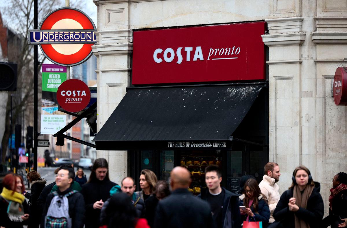 FILE PHOTO: People walk outside a Costa coffee shop in London, Britain, March 4, 2023. REUTERS/Henry Nicholls/File Photo
