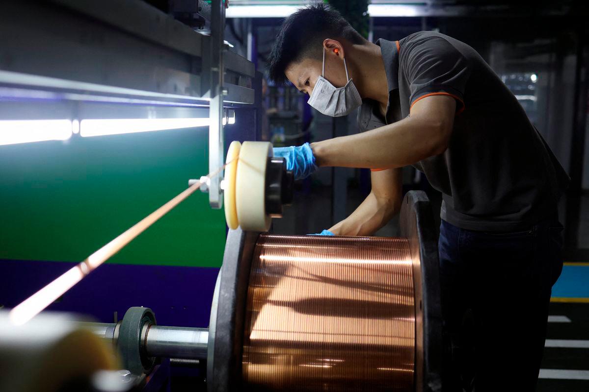 An employee works on the production line for copper flat wire at the Wellascent factory in Ganzhou, Jiangxi province, China August 14, 2025. - REUTERS