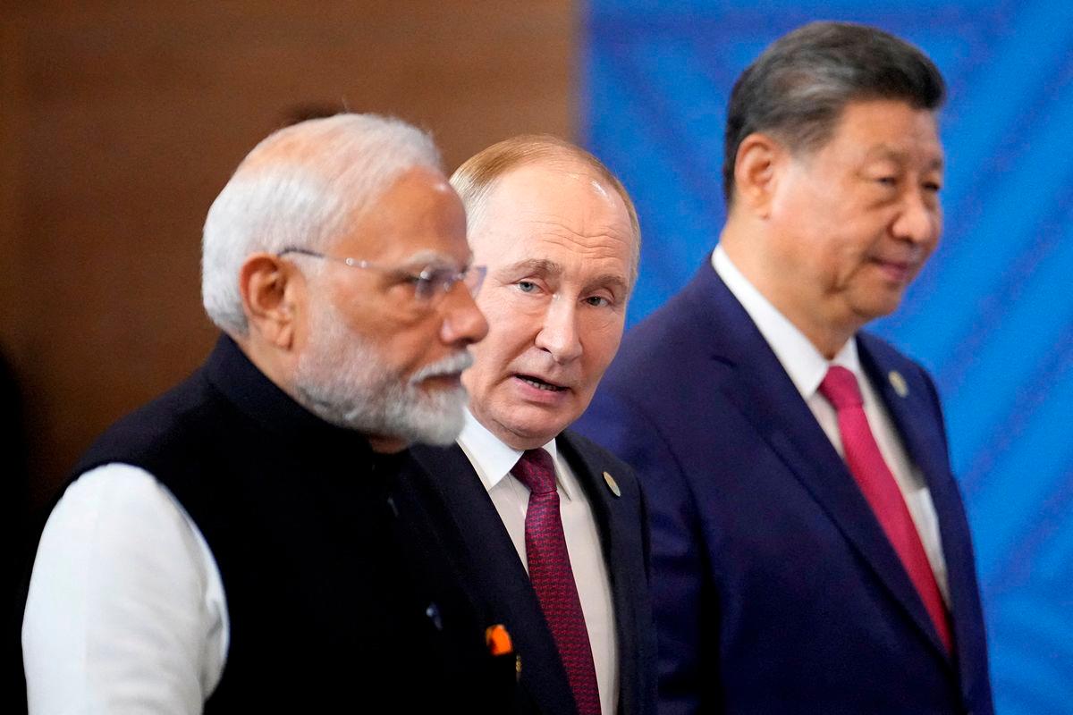 Indian Prime Minister Narendra Modi, Russian President Vladimir Putin and Chinese President Xi Jinping attend a family photo ceremony prior to the BRICS Summit plenary session in Kazan. Pool via Reuterspix