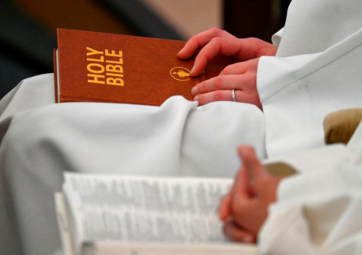 FILE PHOTO: Delegates sit with copies of the Bible whilst attending the Church of England General Synod meeting in London, Britain, February 9, 2023. REUTERS/Toby Melville/File Photo