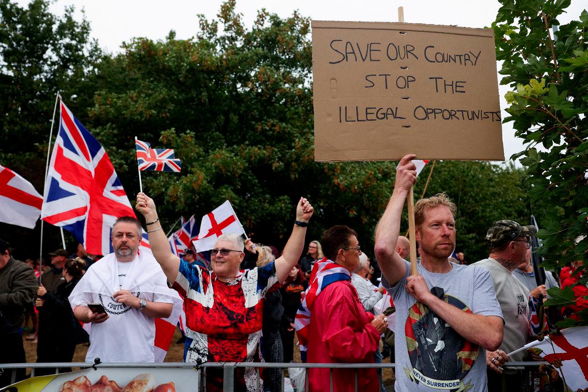 People gather near the IHG Holiday Inn in Woolston as they protest over asylum seekers being housed in the hotel, in Warrington, Britain, August 30, 2025. REUTERS/Temilade Adelaja