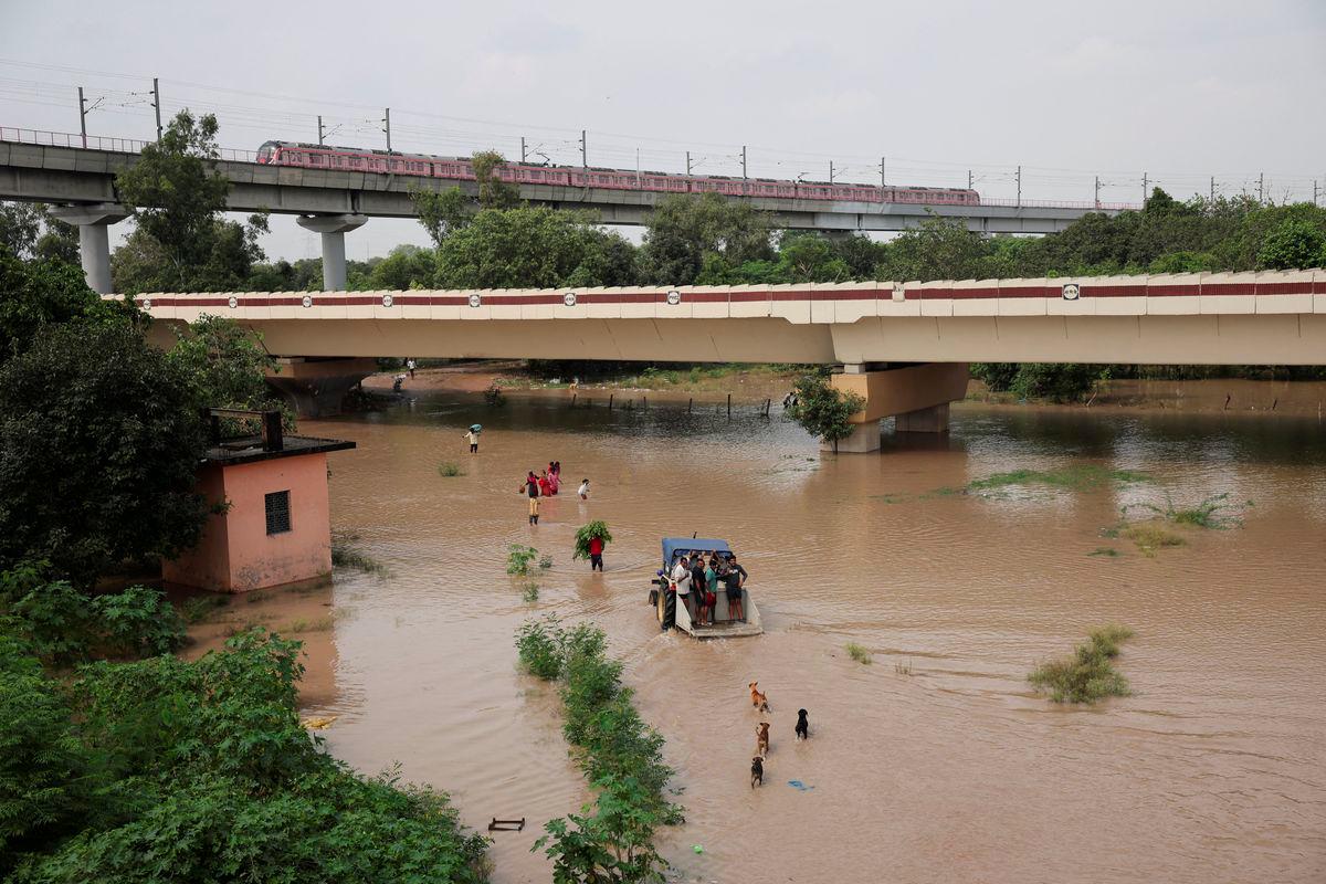People wade through a flooded road after a rise in the water level of river Yamuna due to heavy monsoon rains, in New Delhi, India, September 3, 2025. - REUTERSPIX