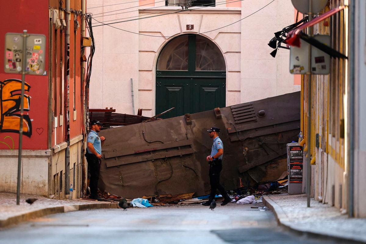 Police officers stand near the site of the accident after Gloria funicular railway car, a popular tourist attraction, derailed and crashed, resulting in multiple casualties, according to authorities, in Lisbon, Portugal, September 4, 2025. REUTERS/Pedro Nunes