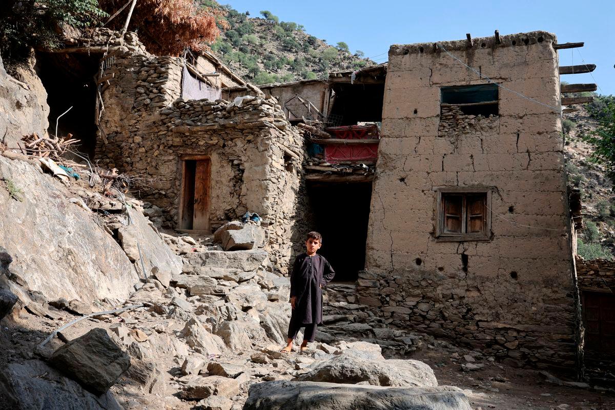 A boy stands in front of houses damaged by a deadly earthquake that struck Afghanistan’s Kunar and Nangarhar provinces, at Masud village in Nurgal district, Kunar province, Afghanistan, September 4, 2025. REUTERS/Sayed Hassib TPX IMAGES OF THE DAY