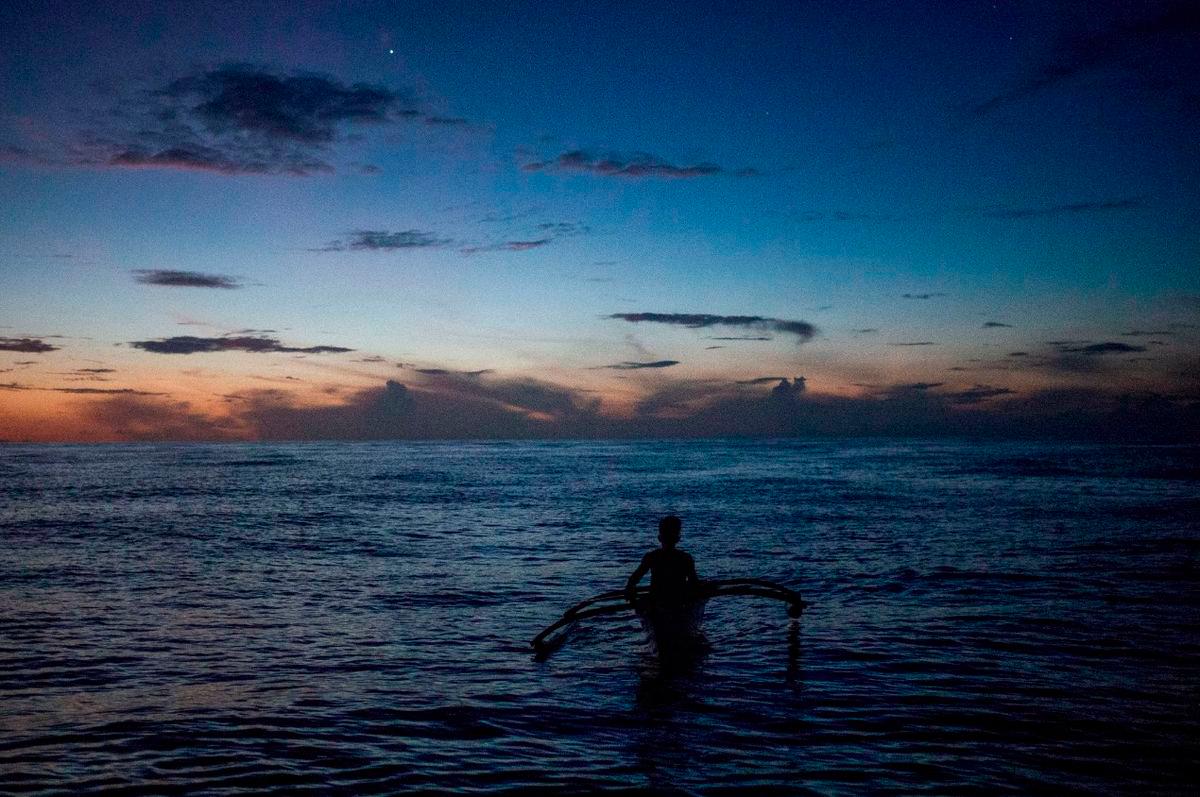 A Filipino fisheman rows a boat during a trip near the disputed Scarborough Shoal, in Masinloc, Zambales province, Philippines, July 18, 2022. - REUTERS