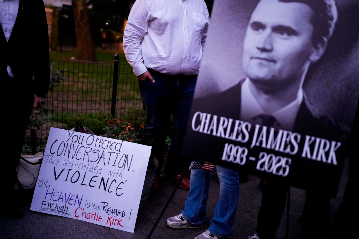 People gather during a vigil for U.S. right-wing activist and commentator Charlie Kirk, who was fatally shot while speaking at an outdoor event at Utah Valley University, at Madison Square Park in New York City, U.S., September 12, 2025. REUTERS/Adam Gray