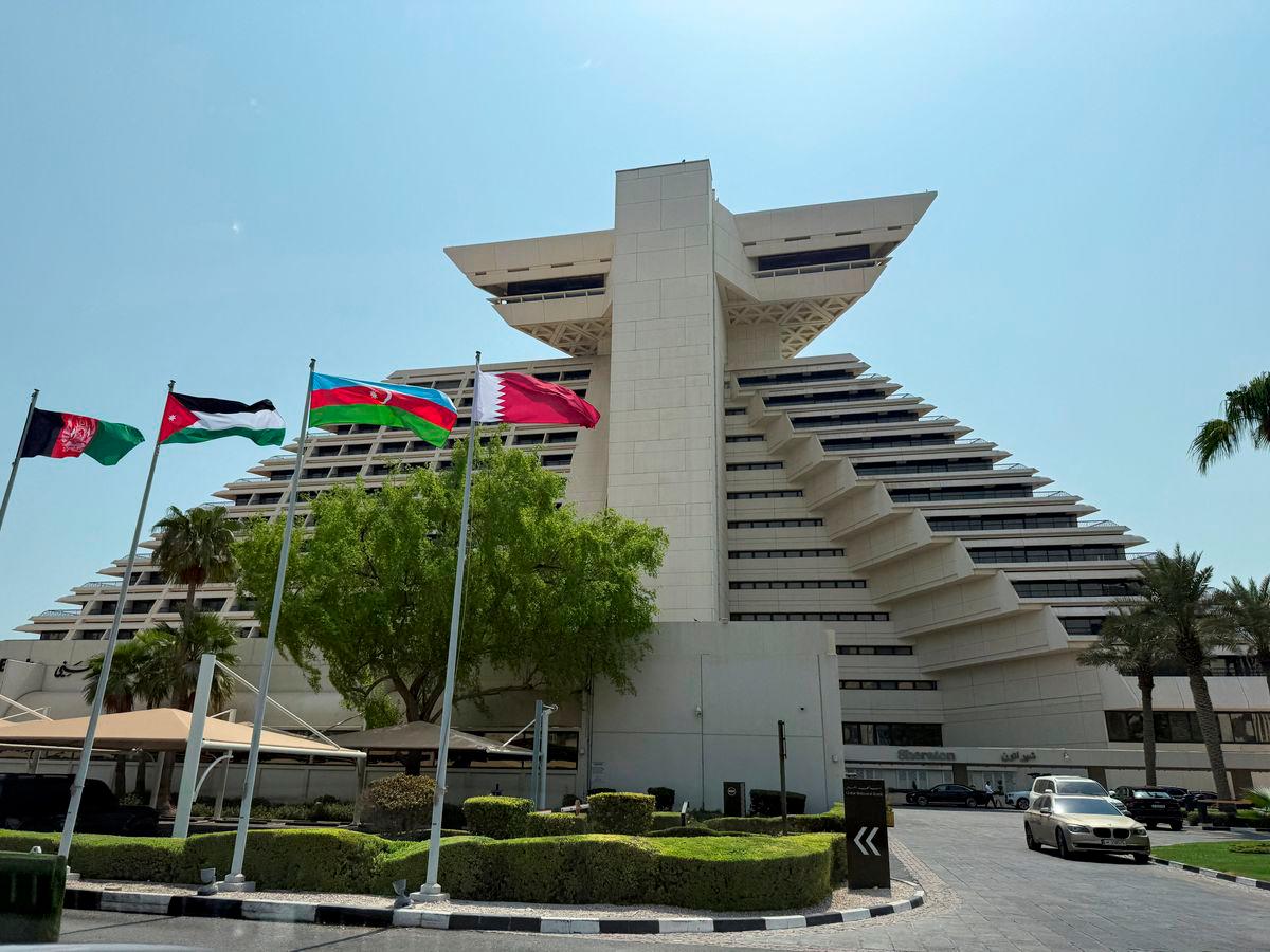 Flags of Afghanistan, Jordan, Azerbaijan and Qatar flutter as Qatar prepares to host the Emergency Arab-Islamic Summit at the Sheraton Hotel, in Doha, Qatar, September 14, 2025. REUTERS/Ibraheem Abu Mustafa
