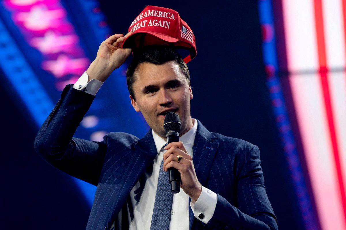 FILE PHOTO: Charlie Kirk, Turning Point USA founder, puts on a MAGA hat during the AmericaFest 2024 conference sponsored by conservative group Turning Point in Phoenix, Arizona, U.S. December 19, 2024. REUTERS/Cheney Orr/File Photo