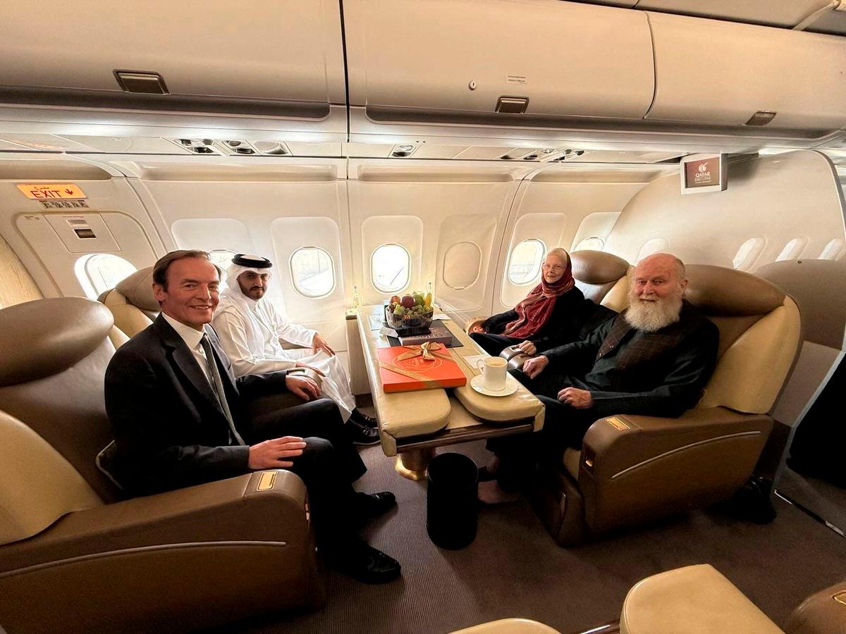 British citizens named Peter and Barbara Reynolds, who had been in custody in Afghanistan, sit with Qatari and British diplomats, on an aircraft, in the air, September 19, 2025. Qatar Government/Handout via REUTERS