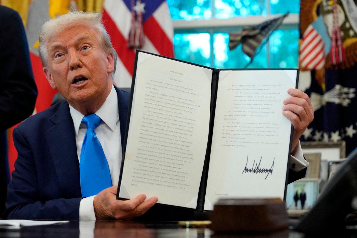 For representational purposes only: U.S. President Donald Trump displays a signed executive order on gold card visa in the Oval Office at the White House in Washington, D.C., U.S., September 19, 2025. REUTERS/Ken Cedeno TPX IMAGES OF THE DAY
