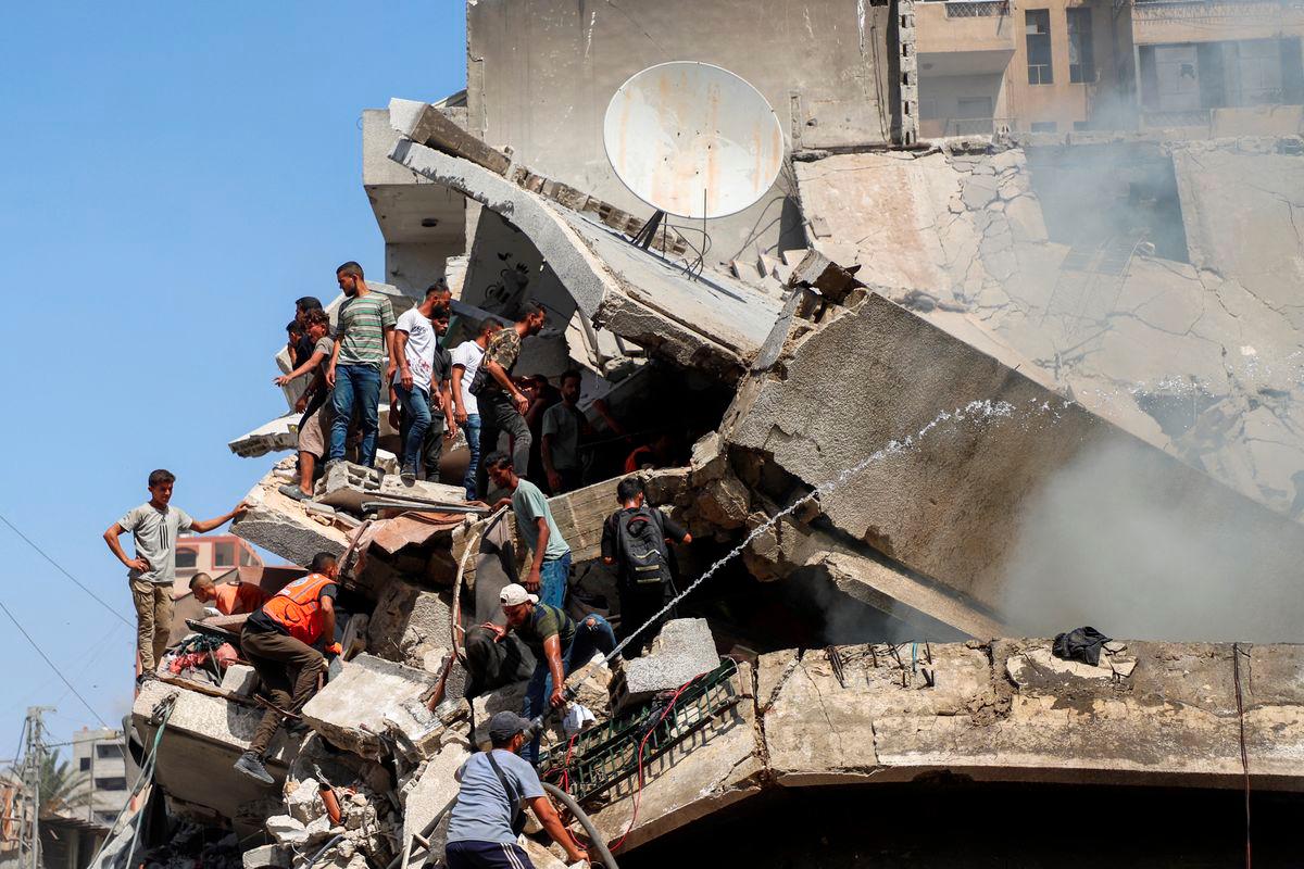 Palestinians search for victims at a residential building hit in an Israeli strike, amid an Israeli military operation, in Gaza City September 22, 2025. - REUTERSPIX