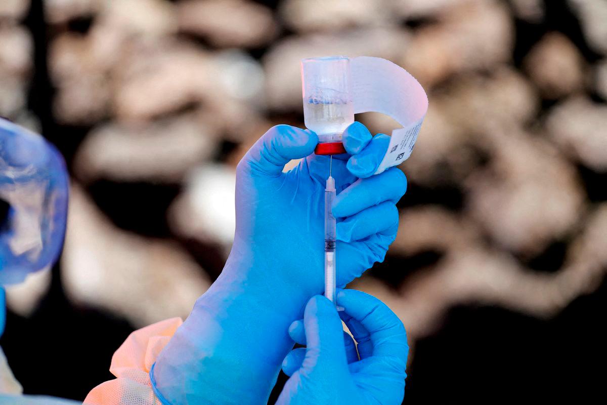 FILE PHOTO: A health worker fills a syringe with Ebola vaccine before injecting it to a patient, in Goma, Democratic Republic of Congo, August 5, 2019. REUTERS/Baz Ratner/File Photo