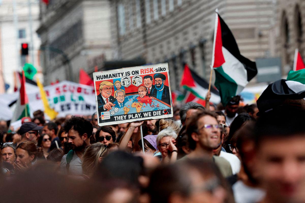 A pro-Palestinian demonstrator carries a placard during a nationwide strike called by the USB union, with the slogan Let's Block Everything, in solidarity with Gaza and calling for a halt to arms shipments to Israel, in Rome, Italy, September 22, 2025. - REUTERSPIX