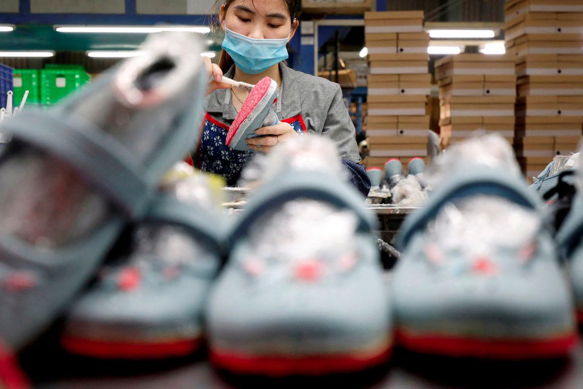 An employee works at a shoe factory for export in Hanoi, Vietnam December 29, 2020. - REUTERSPIX
