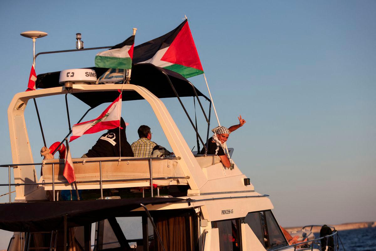 A woman gesture aboard a boat, part of the Global Sumud Flotilla aiming to reach Gaza and break Israel's naval blockade, as it sails off Crete island, Greece, September 25, 2025. - REUTERSPIX