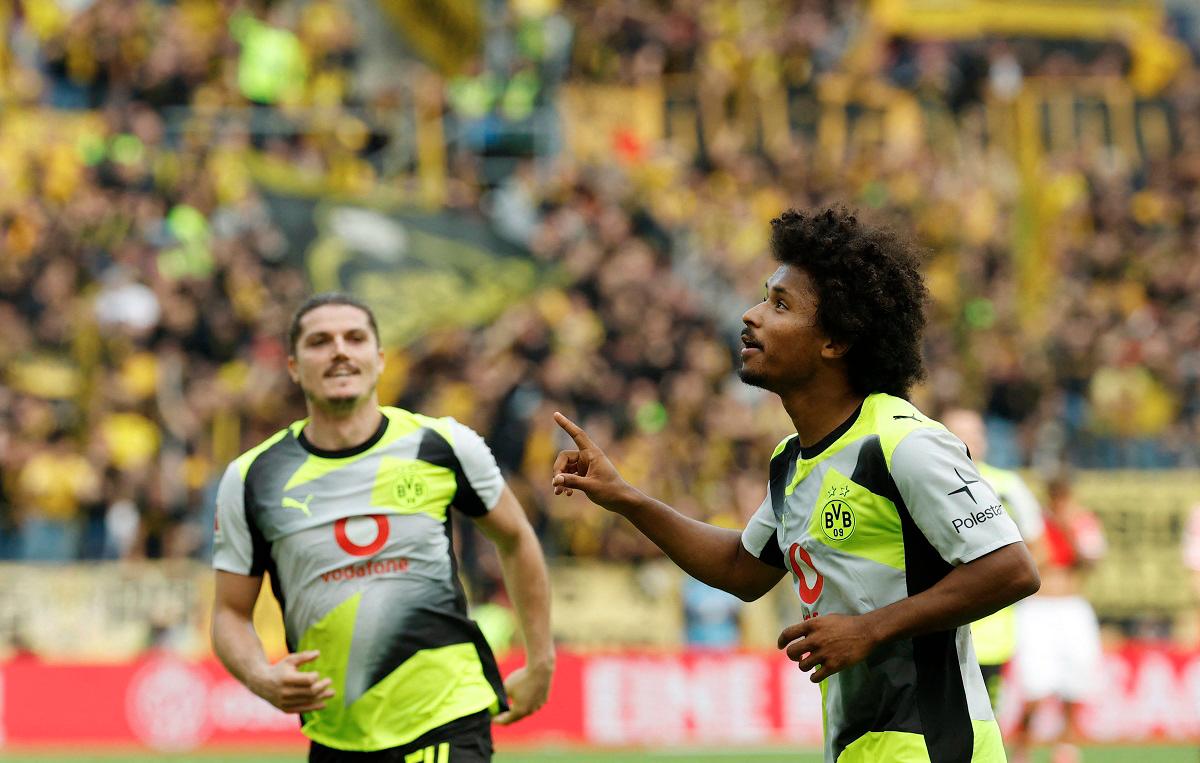 Dortmund’s forward Karim Adeyemi (R) celebrates after scoring his team’s second goal with Dortmund’s midfielder #20 Marcel Sabitzer during the German first division Bundesliga football match between 1 FSV Mainz 05 and Borussia Dortmund in Mainz, western Germany on September 27, 2025. - AFP