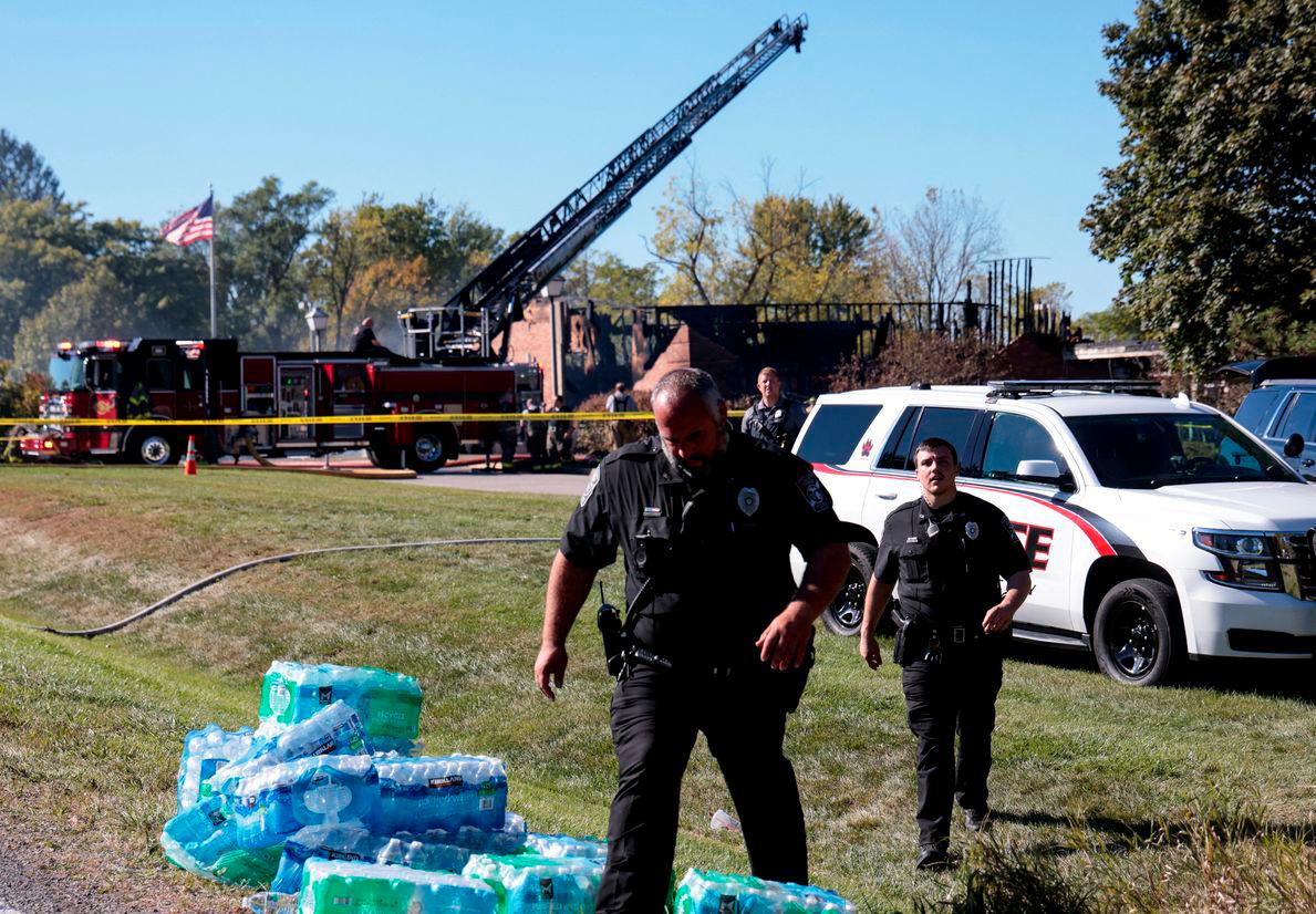 Law enforcement officers work near the burnt Church of Jesus Christ of Latter-day Saints, after a shooting and a fire took place, in Grand Blanc, Michigan, U.S., September 28, 2025. REUTERS/Rebecca Cook TPX IMAGES OF THE DAY