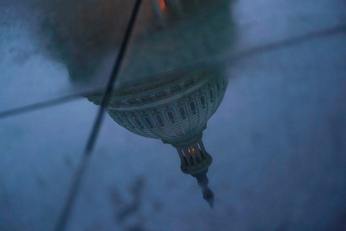 The U.S. Capitol dome is reflected in a puddle on the ground, on the day U.S. President Donald Trump met with top congressional leaders from both parties, just ahead of a September 30 deadline to fund the government and avoid a shutdown, in Washington, D.C., U.S., September 29, 2025. - REUTERSPIX
