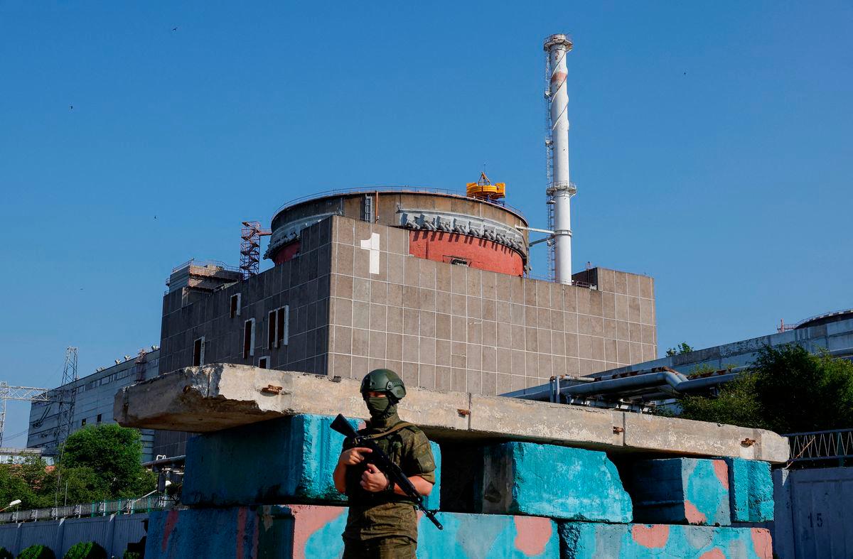 A Russian service member stands guard at a checkpoint near the Zaporizhzhia Nuclear Power Plant - REUTERSPIX